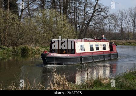 Coppia anziana su narrowboat sul fiume Wey navigazione pirford surrey inghilterra Foto Stock