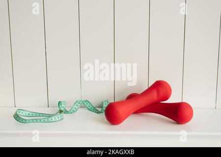 Set di manubri rossi, centimetri, attrezzature sportive, articoli per il fitness Foto Stock