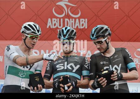 I piloti del Team SKY, di sinistra Nicolas Roche, Michal Kwiatkowski ed Elia Viviani, controllano i loro souvenir del palco che hanno ricevuto, al check-in della firma, prima della fase di apertura del Tour di Abu Dhabi, l'Adnoc Stage, una 147km che corre interamente nel deserto, Con partenza e arrivo a Madinat Zayed. Giovedì 20 ottobre 2016, a Madinat Zayed, Abu Dhabi, Emirati Arabi Uniti. Foto di Artur Widak *** Please use Credit from Credit Field *** Foto Stock