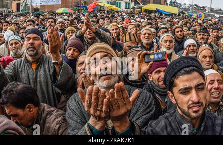 SRINAGAR, KASHMIR, INDIA - GENNAIO 10: I devoti musulmani di Kashmiri pregano guardando verso un chierico (non visto nella foto) che mostra la reliquia Santa creduta di essere di Sufi Saint fuori del santuario di Dastgeer Sahib in occasione dell'Urs annuale (anniversario di nascita) Del 11th ° secolo predicatore Sufi Sheikh Abdul Qadir Jeelani il 10 gennaio 2017 a Srinagar, la capitale estiva del Kashmir controllato indiano, India. Migliaia di musulmani di Kashmiri Sufi si sono riuniti martedì al santuario di Jeelani, conosciuto anche come Shah-e-Baghdad (re di Baghdad), il santuario è chiamato Dastegeer Sahib dopo il ti reverenziale Foto Stock