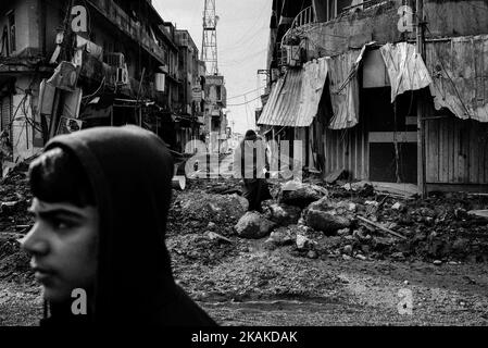 01/22/2017 Mosul, Iraq. Quartiere chiamato al Sukar. Come zucchero. Dovrebbe essere chiamata l'amarezza, almeno dopo che gente di questa città ha sperimentato. Le strade sono segnate da conchiglie, si possono trovare auto relitti sparsi in tutto il mondo. È difficile distinguere quale di essi dovrebbe essere usato in un attacco suicida. Alcuni viali si tormentano con vuoto, mentre gli altri migrano costantemente da un luogo all'altro. La gente vuole condividere le loro storie - 'là, accanto al negozio di pittura terrorista si è esploso'. I suoi resti giacciono sparsi in un mucchio di spazzatura. In realtà, CE ne erano due Foto Stock