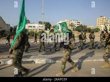 I membri delle ali armate dei gruppi palestinesi marciano durante una parata, organizzata per mostrare la loro solidarietà alla resistenza contro le restrizioni di Israele sul complesso della moschea di al Aqsa a Gaza City, Gaza il 25 luglio 2017. Israele ha introdotto nuove restrizioni per i palestinesi che vogliono entrare nel complesso della moschea di al Aqsa. *** Utilizzare il campo credito da credito *** Foto Stock