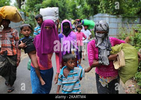 La gente di Rohingya, fuggita dall'operazione militare in corso nello stato di Myanmar Rakhain, cammina lungo la strada all'isola di Shah pori per andare al campo profughi nell'isola di Shah pori in Bangladesh il 07 ottobre 2017. Il popolo di Rohinngya è fuggito continuando in Bangladesh. Il Bangladesh ha affermato che sarebbe stata una delle più grandi camme di rifugiati del mondo ad ospitare tutti i 800.000 più musulmani Rohingya che hanno cercato asilo dalla violenza in Myanmar. (Foto di Zakir Hossain Chowdhury/NurPhoto) Foto Stock