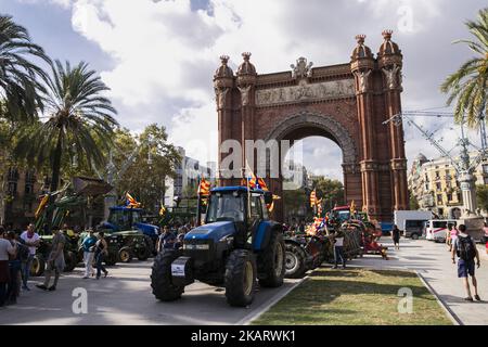 I contadini che sostengono l'indipendenza catalana guidano con i trattori attraverso l'Arc de Triomf vicino al Parlamento della Catalogna dove Carles Puigdemont potrebbe dichiarare l'indipendenza della Catalogna. A Barcellona il 10 ottobre 2017. (Foto di Xavier Bonilla/NurPhoto) Foto Stock