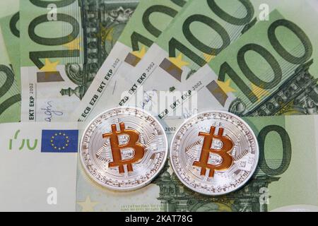 Le monete simboliche di criptovaluta Bitcoin sono viste davanti alle banconote da 100 euro in questa illustrazione fotografica a Danzica, Polonia, il 1 novembre 2017. Il prezzo del bitcoin ha superato la barriera di 6.500 e 6.600 dollari in un giorno per raggiungere un nuovo record il 1 novembre, dopo che CME, con sede negli Stati Uniti, ha dichiarato che avrebbe introdotto contratti futures bitcoin questo trimestre, previa approvazione normativa. (Foto di Michal Fludra/NurPhoto) Foto Stock