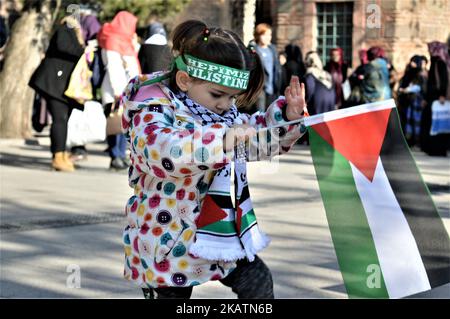 Una foto scattata ad Ankara in Turchia il 8 dicembre, 2017 mostra una bambina che sventola una bandiera palestinese mentre i musulmani turchi prendono parte a una protesta fuori dalla Moschea di Haci Bayram dopo una tradizionale preghiera del venerdì contro il riconoscimento ufficiale del presidente degli Stati Uniti Donald Trump la città di Gerusalemme come capitale d'Israele il 6 dicembre. (Foto di Altan Gocher/NurPhoto) Foto Stock