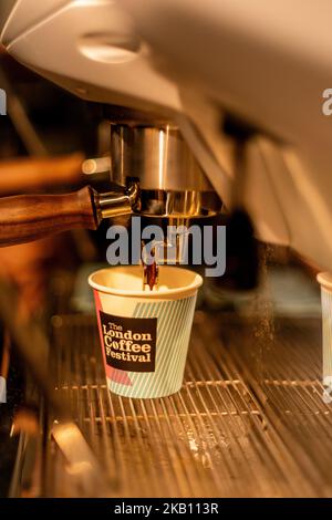 Primo piano portafiltro, che estrae il caffè espresso in un piccolo bicchiere al festival del caffè di Londra Trumans Brewery East End di Londra Foto Stock