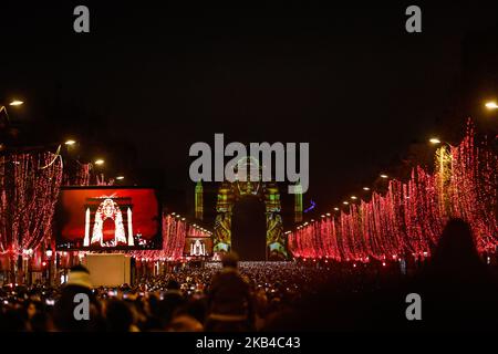 La gente si riunisce vicino all'Arco di Trionfo illuminato sugli Champs-Elysees per le celebrazioni di Capodanno nella capitale francese Parigi il 31 dicembre 2018. Uno spettacolo di fuochi d'artificio e uno spettacolo di suoni e luci con il tema 'Fraternity' e' allestito a Passi pure sugli Champs-Elysees nonostante i piani per ulteriori proteste anti-governative 'gileta' nel famoso viale. (Foto di Sameer al-Doumy/NurPhoto) Foto Stock