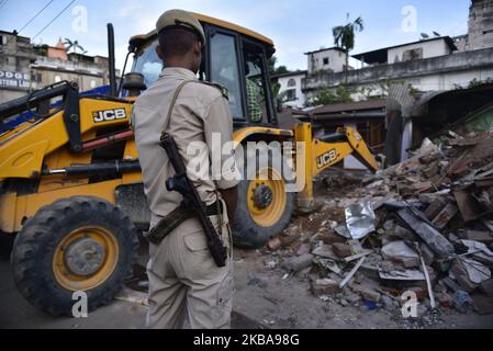 Un personale della polizia accanto a un'unità di sfratto da parte dell'amministrazione, a Nayanpur in Guwahati, Assam, India il giovedì, 7 novembre 2019. (Foto di David Talukdar/NurPhoto) Foto Stock