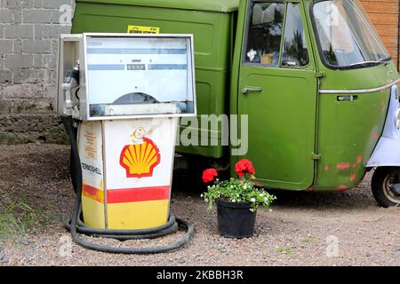 Distributore di benzina Old Shell della Avery-Hardoll in cantiere con veicolo Piaggio Ape verde a tre ruote. Riihikoski, Finlandia. Giugno 11, 2022. Foto Stock