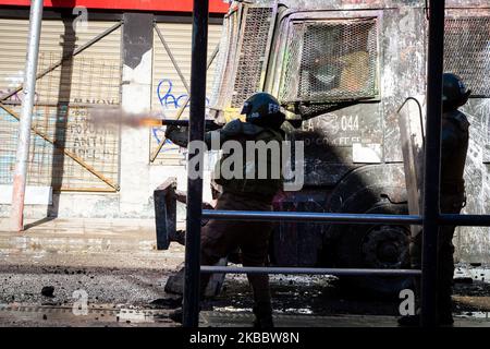 Riot police fire tear gas to disperse supporters during a protest against government of President Sebastian Pinera at Plaza Italia on November 28, 2019 in Santiago, Chile. For more than 40 days the conflicts and demonstrations keep on going in Santiago of Chile, capital of Chile. The protest is against the politics of their president Sebastian Pinera.(Photo by Federico Rotter/NurPhoto) Stock Photo