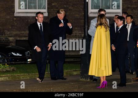 (L-R) French President Emmanuel Macron, US President Donald Trump and First Lady Melania Trump arrive in Downing Street to attend a reception for NATO leaders hosted by British Prime Minister Boris Johnson on 03 December, 2019 in London, England, ahead of the main summit tomorrow held to commemorate the 70th anniversary of NATO. (Photo by WIktor Szymanowicz/NurPhoto) Stock Photo