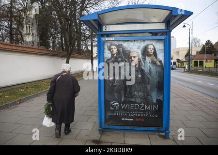A poster promoting 'The Witcher' Netflix television series is seen at a bus stop in Krakow, Poland on 20 December, 2019. Netflix 'The Witcher' (Polish: Wiedzmin) created by Lauren Schmidt Hissrich and starring Henry Cavill, Anya Chalotra and Freya Allan is based on the book series of the same name by Polish writer Andrzej Sapkowski. (Photo by Beata Zawrzel/NurPhoto) Stock Photo