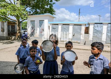 Student are waiting for mid day meal at at Tiffin break in Tehatta, India, on 28 December 2019. Mid-day meal scheme is a school meal program of the Government of India designed to better the nutritional standing of school-age children nationwide. (Photo by Soumyabrata Roy/NurPhoto) Stock Photo