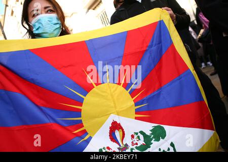 Una donna detiene una bandiera del Tibet mentre attivisti si radunano in solidarietà con il movimento pro-democrazia di Hong Kong e in protesta per il trattamento della Cina nei confronti dei suoi popoli tibetano e uighur in occasione di una manifestazione per tutte e tre le cause al di fuori dell'ambasciata cinese a Londra, in Inghilterra, il 19 gennaio 2020. Nel suo recentemente pubblicato "World Report 2020", la scorsa settimana l'ONG di ricerca e di difesa di New York Human Rights Watch ha individuato una "repressione deepening" da parte delle autorità cinesi nel corso del 2019, tra cui le libertà religiose in Tibet e nella patria uigura dello Xinjiang, come la caratteristica distintiva di ciò che era il 70th° anno Foto Stock