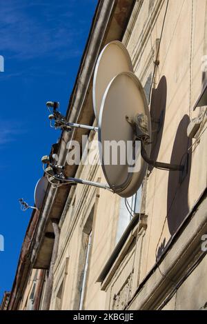 Due antenna satellitare e televisione sul tetto, bella luce fare con filtro Foto Stock