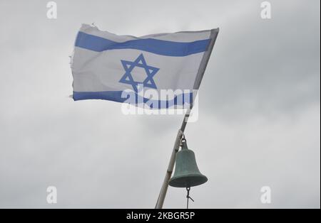 An Israeli national flag seen at Tel Aviv beach during a stormy weather. Israel's Mediterranean coast, including the city of Tel Aviv, experiance a few days of winter storms with low temperatues and rain. On Monday, 10 February 2020, in Tel Aviv, Israel. (Photo by Artur Widak/NurPhoto) Stock Photo