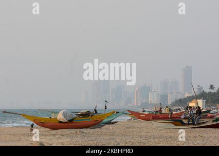 Boats have been parked on the shore. Behind it is the view of capital Colombo city on February.24.2020 (Photo by Akila Jayawardana/NurPhoto) Stock Photo