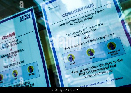 Signs offer advice regarding the covid-19 coronavirus in a window at the entrance to University College Hospital, which houses a 'coronavirus pod' isolation unit, in London, England, on February 27, 2020. Concern continues over the pandemic potential of the virus, with cases now being confirmed in a steadily increasing number of countries around the world. Two further coronavirus cases were confirmed today in the UK, bringing the total so far to 15. (Photo by David Cliff/NurPhoto) Stock Photo