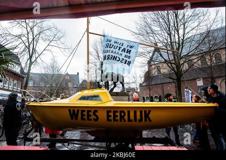 The ship from the climate group Extinction Rebellion was carried during the climate march in Utrecht, Netherlands, on February 29th, 2020. Under the motto: On the eye of the storm, hundreds of climate activists walked to the City Hall. There they presented their five demands: keep people informed, protect the Amelisweerd forest area, make the city center car-free and public transport free, plant 10,000 trees and encourage biodiversity, and guarantee truly sustainable energy. The demonstration was organized by several Climate organizations, between them was Extinction Rebellion, Fridays for Fut Stock Photo