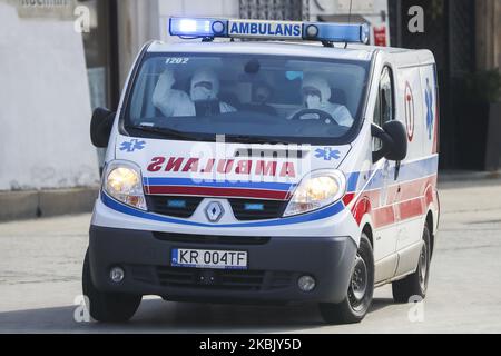 Il personale medico che indossa maschere protettive e tute guida un'ambulanza utilizzando sirene a Cracovia, Polonia, il 13 marzo 2020. Il Ministero della Salute ha annunciato venerdì pomeriggio il numero di casi di coronavirus in Polonia è salito di 64 con una persona morta a causa di infezione. Il presidente ha annunciato che per ora il paese non sta considerando l'introduzione di uno stato di emergenza per la crisi. (Foto di Beata Zawrzel/NurPhoto) Foto Stock