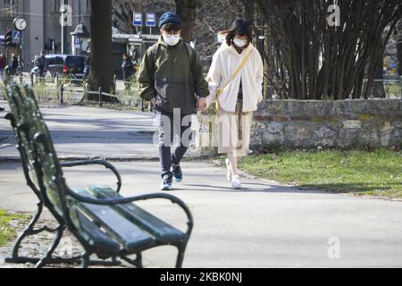 Tourists are seen wearing protective face masks while walking around Krakow, Poland on March 14, 2020. Due to the spread of coronavirus the Polish Prime Minister has introduced a state of epidemic threat, in force as of Saturday, which will include controls on the country’s borders and restrictions imposed on services such as museums, restaurants, pubs and shopping malls. (Photo by Beata Zawrzel/NurPhoto) Stock Photo