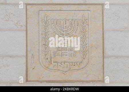 The Emblem of the State of Israel, a menorah surrounded by an olive branch on each side, and the writing Israel (In Hebrou), seen at the entrance to the National Hall For Israel's Fallen, in Mount Herzl, Jerusalem. On Wednesday, March 11, 2020, in Jerusalem, Israel. (Photo by Artur Widak/NurPhoto) Stock Photo