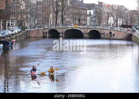 Due Womaen pratica canoa sul tranquillo e vuoto canale Sngel il 1 aprile 2020 ad Amsterdam, Paesi Bassi. Il primo ministro olandese Mark Rutte ha annunciato ieri che il governo ha esteso le misure volte a combattere la diffusione del coronavirus fino al 28 aprile 2020 (Foto di Paulo Amorim/NurPhoto) Foto Stock