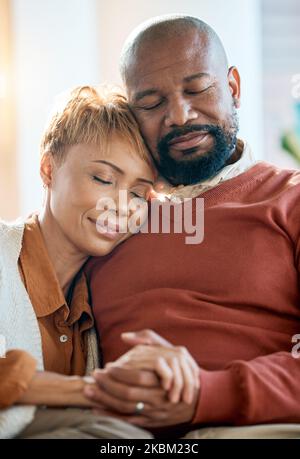 Senior black couple, holding hands on sofa or comfort bonding care with smile happiness in home living room. Mature black man, happy black woman on Foto Stock