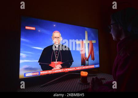 Una signora guarda un replay di un messaggio televisivo di Mons. Stanislaw Gadecki, presidente della Conferenza Episcopale Polacca, su TVP News nella sua stanza. Le celebrazioni pasquali di quest’anno in tutta la Polonia sono silenziate, sobrie e prive delle solite e vivaci celebrazioni alle quali il paese è associato da secoli, grazie al romanzo coronavirus, chiamato pandemia COVID-19. Domenica 12 aprile 2020 a Cracovia, Polonia. (Foto di Artur Widak/NurPhoto) Foto Stock