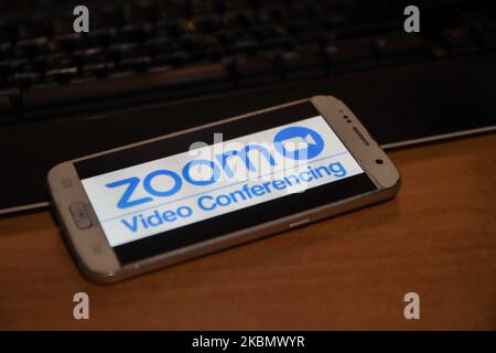 ZOOM Video Communications viene visualizzato sullo schermo del telefono, le miniature dell'applicazione, dello smartphone e della tastiera vengono visualizzate in questa illustrazione con esposizione multipla. Zoom è un'azienda americana di tecnologia delle comunicazioni con sede a San Jose, California. Fornisce servizi di videotelefonia e chat online tramite una piattaforma software peer-to-peer basata su cloud ed è utilizzata per teleconferenze, telelavoro, formazione a distanza e relazioni sociali. Zoom App e la comunicazione divenne molto popolare durante il Covid-19, Coronavirus pandemic quarantena blocco e distensione sociale come la gente starte Foto Stock