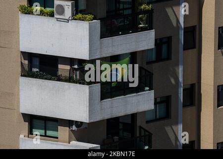 A Brazilian flag is seen extended on the balcony during the quarantine period amid the outbreak of coronavirus disease (COVID-19) in Santos, Brazil, April 27, 2020. (Photo by Felipe Beltrame/NurPhoto) Stock Photo