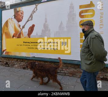 Un uomo cammina accanto a un poster di Jean Paolo II nel centro di Cracovia. Karol Wojtyla, 18 maggio 1920 1978 – 2 2005 aprile 2005, è stato un . Prima, dal 1964 al 1974, fu arcivescovo di Cracovia. Sabato 16 maggio 2020 a Cracovia, Polonia. (Foto di Artur Widak/NurPhoto) Foto Stock