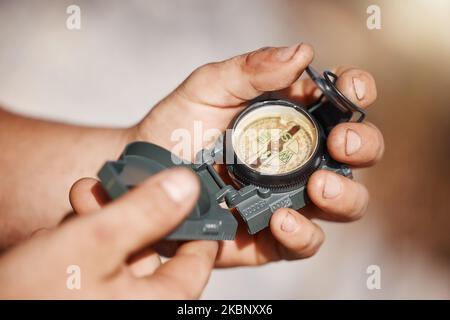 Hiking man, hands or pocket compass in travel location, camping ground direction or destination arrow map. Zoom, navigation device or magnetic north Stock Photo