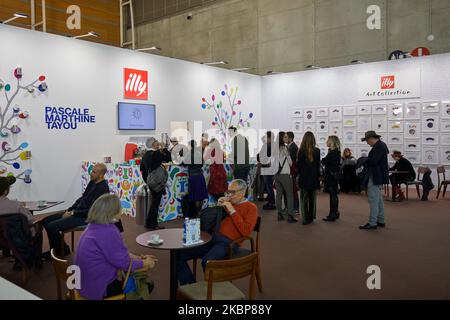 TURIN, ITALY - NOVEMBER 04, 2022: Illy coffee stand with people and Pascale Marthine Tayou artwork at Artissima 2022, contemporary art fair vernissage Stock Photo