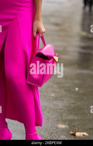 Parigi, Francia - Ottobre, 2, 2022: Donna indossa lana fucsia e cappotto misto cashmere e borsa tote rosa piccola in pelle Stud, stile Street Foto Stock