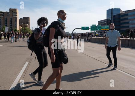 Protesters look on in disbelief after a fuel truck drove through a crowd of thousands on the I-35W bridge in Minneapolis, MN. May 31, 2020. (Photo by Tim Evans/NurPhoto) Stock Photo