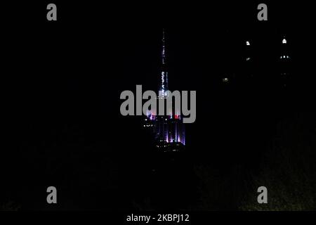 A view of Empire State Building flashing different colors as protestors are seen assembling in a rally against the death of Minneapolis, Minnesota man George Floyd at the hands of police on May 31, 2020 in New York City. Floyd's death was captured in video that went viral of the incident. (Photo by John Nacion/NurPhoto) Stock Photo