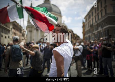 A man waves Italian flag during a protest held by movement 'Orange Vests' (Gilet Arancioni) against the government on June 2, 2020 in Piazza del Popolo in Rome, Italy. Hundreds of protesters shunning masks gathered in Rome's Piazza del Popolo to demonstrate against the government measures taken to stop the spread of coronavirus. (Photo by Christian Minelli/NurPhoto) Stock Photo