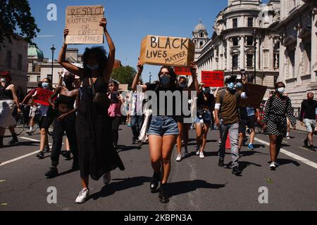 Activists gathered in protest at the killing of George Floyd march along Whitehall in London, England, on May 31, 2020. Thousands came together for the protest, despite ongoing concerns over the possible spread of coronavirus and continuing calls by authorities for social distancing guidelines to be adhered to. Floyd, a black man, died as a white police officer, Derek Chauvin, knelt on his neck during an arrest in the US city of Minneapolis on May 25. Floyd's death, reminiscent of the chokehold death of Eric Garner at the hands of police officers in New York in 2014, has reignited the 'Black L Stock Photo