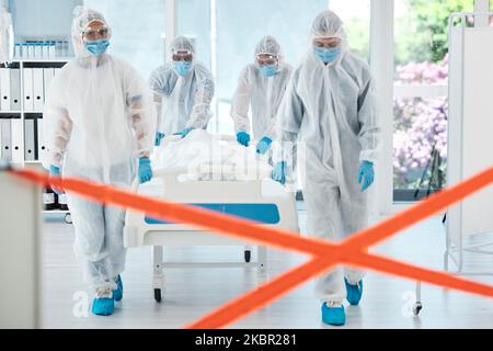 Healthcare doctor, covid patient or quarantine red tape zone with team in hazmat suit for bacteria, sick or dead person in hospital. Medical PPE covid Stock Photo