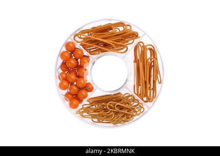 Paper clip dispenser, orange color pins and clips collection. Office supplies, isolated on white background.Top view. Flat lay design. Round transpare Stock Photo