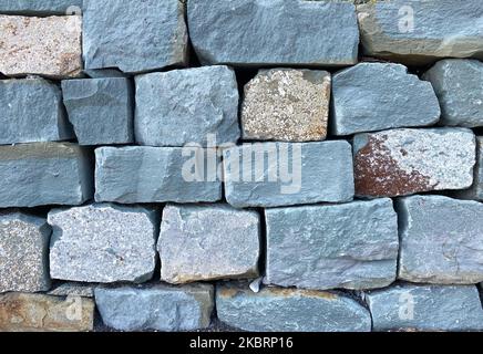 Muro di pietra da sfondo di pietre grezze Foto Stock