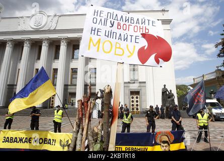 Ukrainian police officers stand guard during a rally against a bill which allows to reduce the use of the Ukrainian language in schools, near the Ukrainian Parliament building in Kyiv, Ukraine, on 17 July, 2020. Ukrainians gathered for their protest against adoption of the draft bill ? 2362 'On amendments to some legislative acts of Ukraine regarding the teaching of the state language in educational institutions', which provides for the abolition of the transition of students in grades 5-11 of Russian-language schools to the Ukrainian language of instruction from 01 September 2020 and permissi Stock Photo