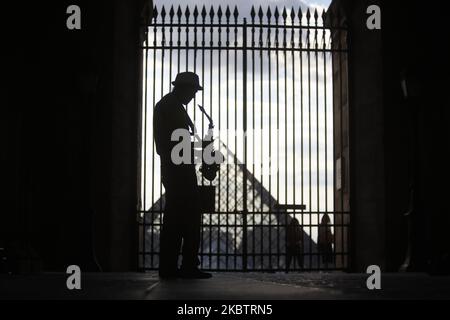 Un uomo suona il sassofono davanti al Museo del Louvre a Parigi, in Francia, il 17 luglio 2020. (Foto di Mehdi Taamallah/NurPhoto) Foto Stock