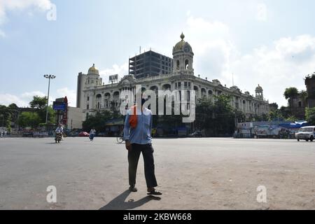 A man walks through the deserted road during the second day lock down enforced by the govt. of West Bengal. On July 25, 2020 in Kolkata, India. (Photo by Sukhomoy Sen/NurPhoto) Stock Photo