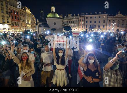 Manifestanti visti nella piazza principale del mercato di Cracovia. I membri della diaspora locale bielorussa, gli attivisti e i sostenitori locali si sono nuovamente stuaccati sabato sera per esprimere la loro solidarietà con i bielorussi durante il Rally di solidarietà organizzato a Cracovia. Il 15 agosto 2020, a Cracovia, Polonia. (Foto di Artur Widak/NurPhoto) Foto Stock