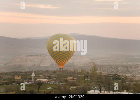 Mongolfiera che sorvola la spettacolare Cappadocia, castello di Uchisar sullo sfondo - Goreme, Turchia Foto Stock