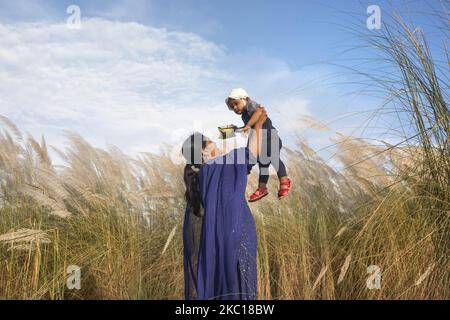 La gente sta visitando il campo di erba catkin in mezzo alla pandemia COVID-19 in Aftab Nagar, alla periferia della Dhaka, Bangladesh il 05 ottobre 2020. Dopo il blocco durante la pandemia, le persone di Dhaka tornano alla vita normale e Aftab Nagar è una delle destinazioni popolari e attraenti, dove molte persone vanno con le loro famiglie e amici per rinfrescarsi. (Foto di Kazi Salahuddin Razu/NurPhoto) Foto Stock