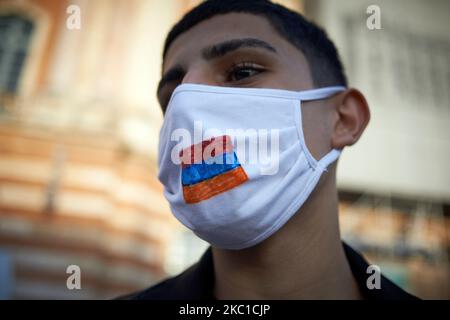 Un giovane protester indossa una maschera facciale con una bandiera armena dipinta su di essa. Gli armeni di Tolosa hanno organizzato una marcia per gli armeni e il Nagorno-Karabakh. Volevano anche sensibilizzare il pubblico sul conflitto nel Nagorno-Karabakh. Depiste chiede dal gruppo di Minsk (Francia, Russsia e USA) un cessate il fuoco immediato per evitare una guerra più ampia nel Caucaso meridionale, la guerra tra Armenia e Azerbaigian continua ad aumentare. La Turchia, un vicolo vicino all'Azerbaigian, potrebbe essere risucchiata nel conflitto come la Russia che ha un patto di difesa con l'Armenia. Anche l'Armenia (come la Russia e la Francia) ha accusato la Turchia di militari Foto Stock